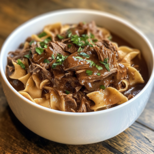 Slow Cooker Beef and Noodles with tender beef chunks and soft noodles in a savory broth.