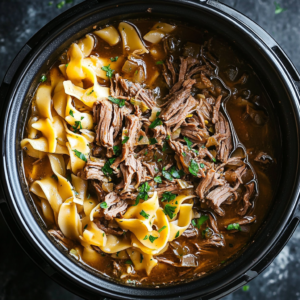 Slow Cooker Beef and Noodles with tender beef chunks and soft noodles in a savory broth.