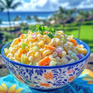 Bowl of creamy Hawaiian mac salad with carrots and celery on a tropical background